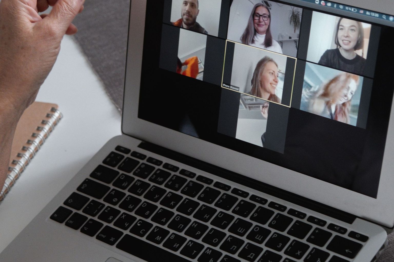 A laptop shows a group video call for online learning.