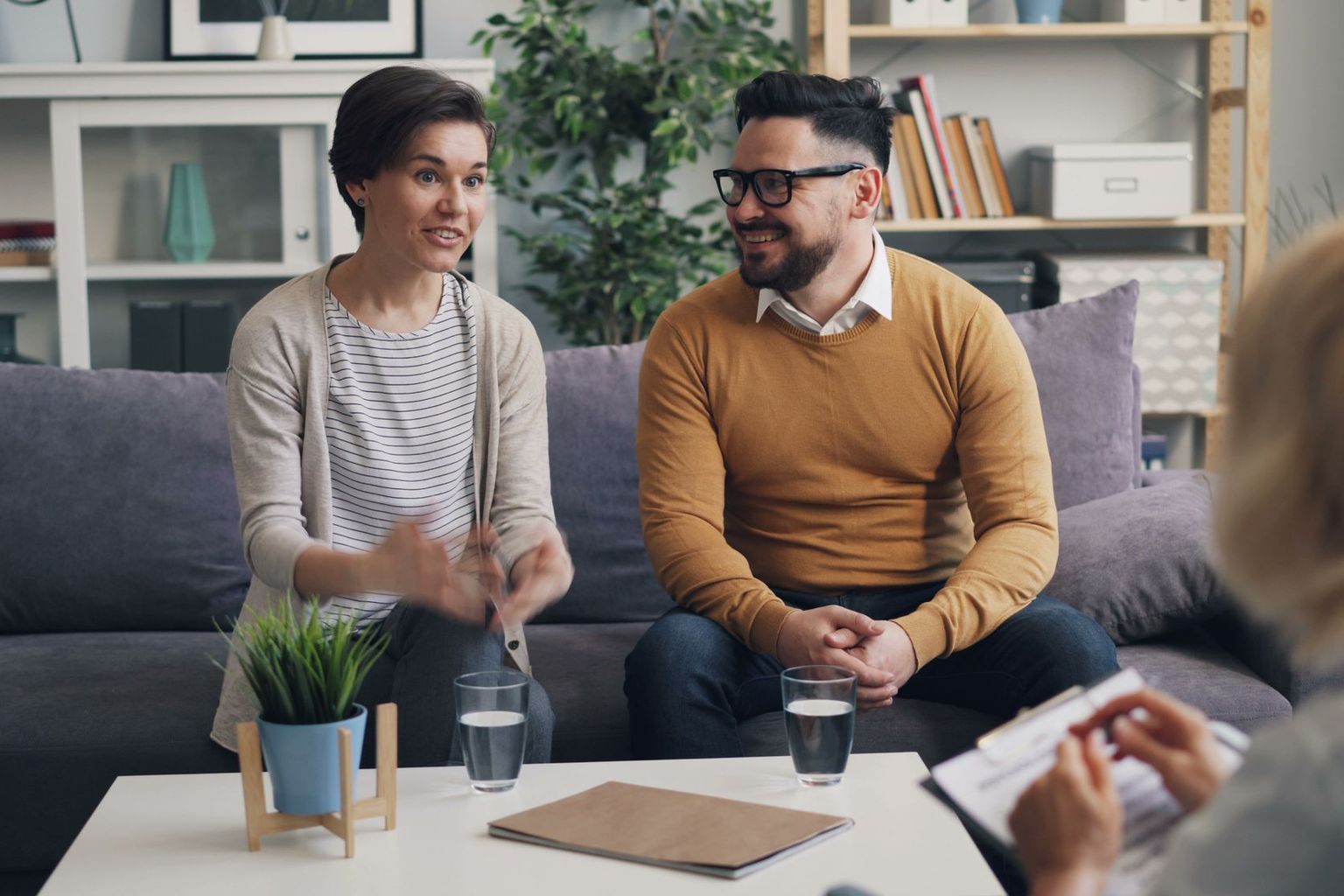 Two people talk openly in a calm, supportive setting.